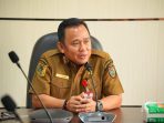 Seorang pejabat Dinas ESDM Kalimantan Tengah sedang memberikan penjelasan mengenai aturan izin pertambangan Galian C dalam wawancara resmi.